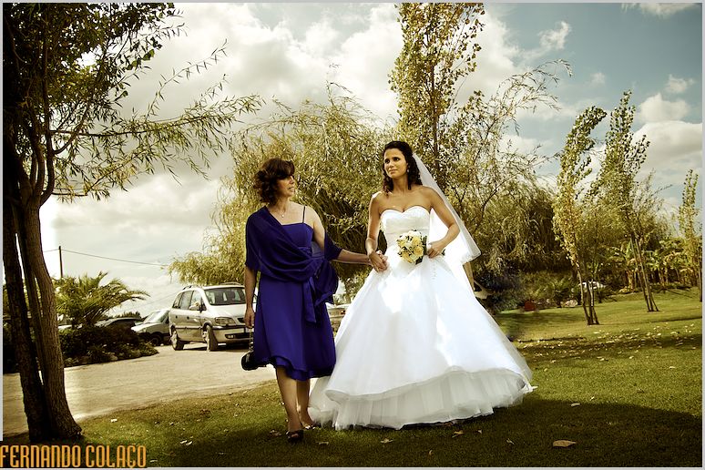 Bride, with her mother, walks to the location of the wedding ceremony.