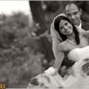 Bride leans against the groom who holds her from behind, in the session with the wedding photographer at Quinta Madredeus.