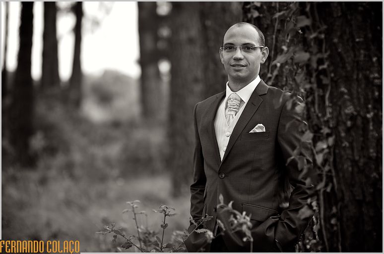 A black and white portrait of the groom.