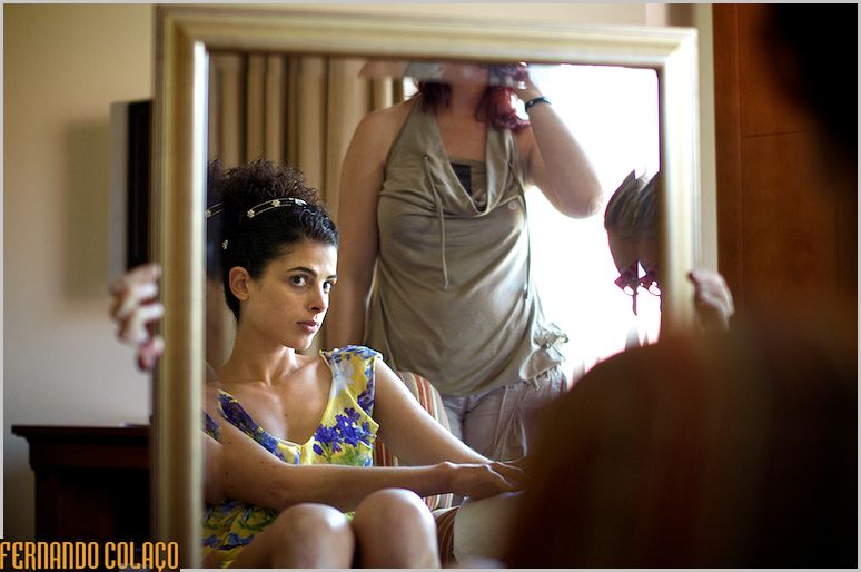 Bride looking at herself in the mirror, judging her hairstyle.