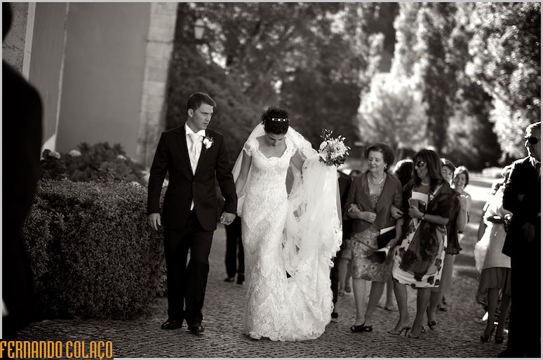 Bride and groom in front of guests, walking to socialize at Penha Longa Resort.