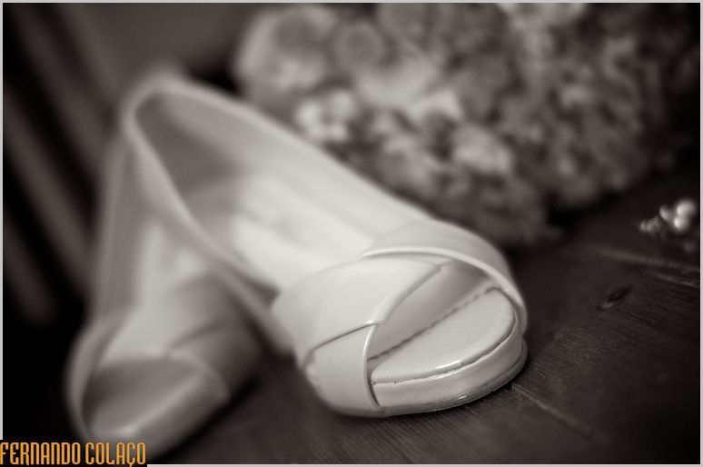 The bride's shoes on the floor.