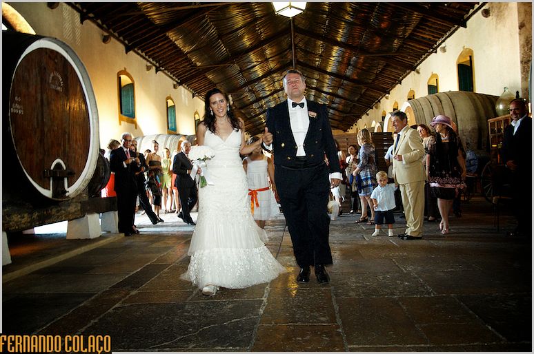 The bride with her father walks through the Adega Regional de Colares for the wedding ceremony.
