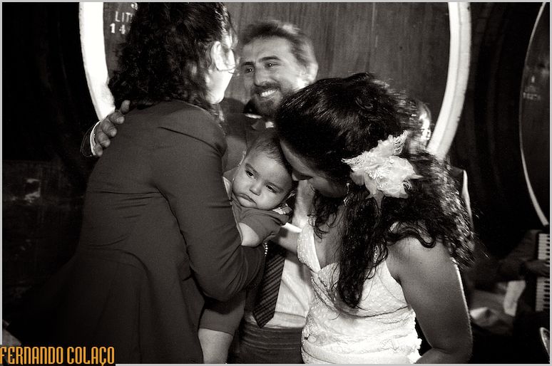 The bride and groom with a mother with a child in her arms, during greetings.