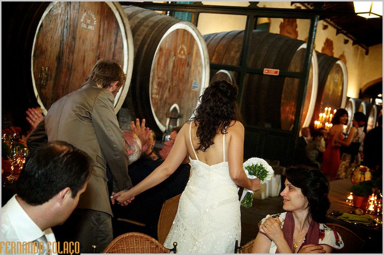 The bride and groom walk the path between the wedding meal tables.