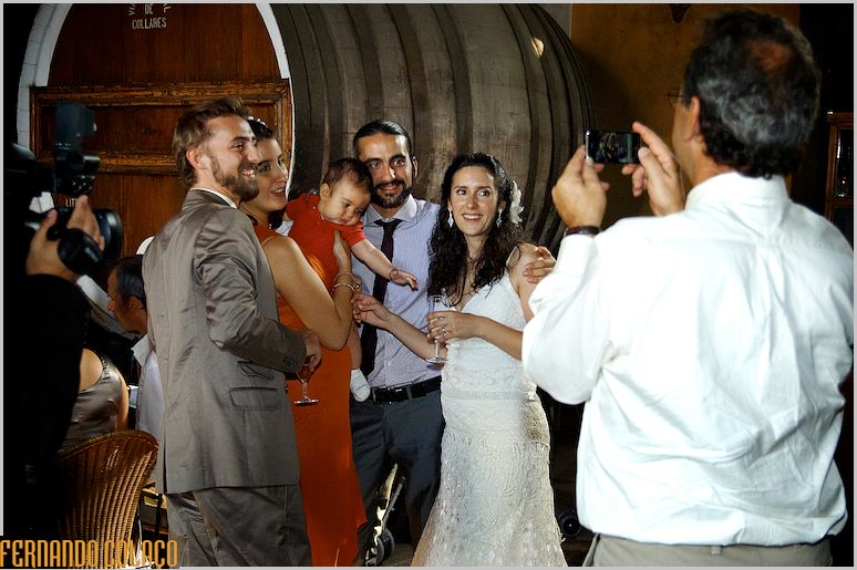 The bride and groom together with friends to whom they take a picture.