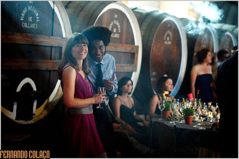 A couple, at the wedding party, in front of the kites at the Adega Regional de Colares.