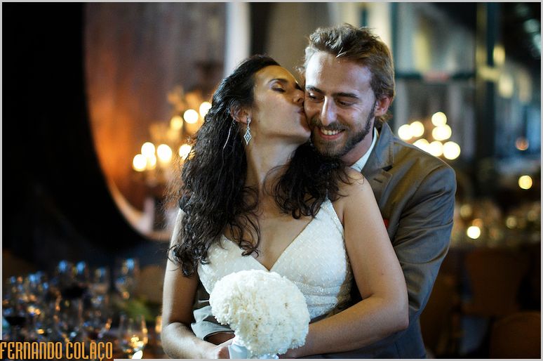 The bride kisses the bride in a photo session with the wedding photographer.