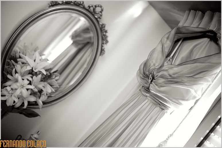 Bride's dress next to a mirror.