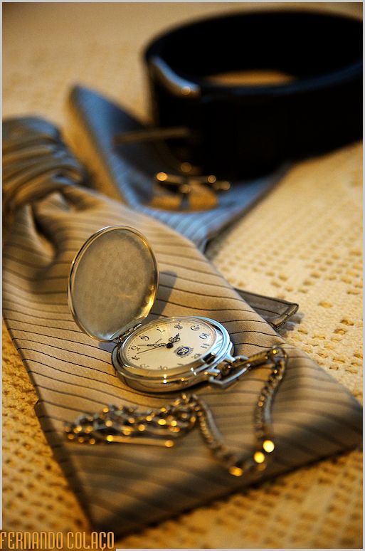 Pocket watch on the groom's tie.