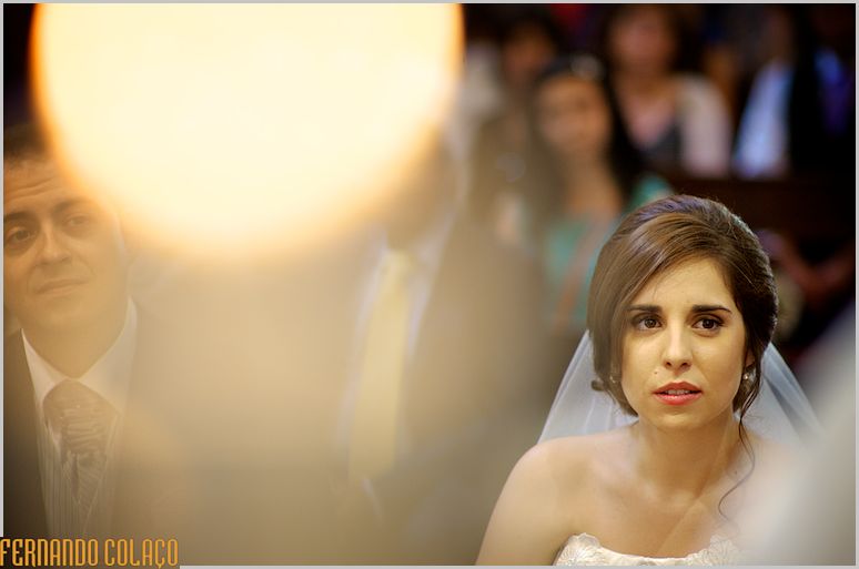 Beneath a ball of yellow light, the groom and bride at their wedding ceremony.