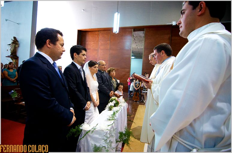 Grooms, godparents and officiating priests, before the wedding ceremony.