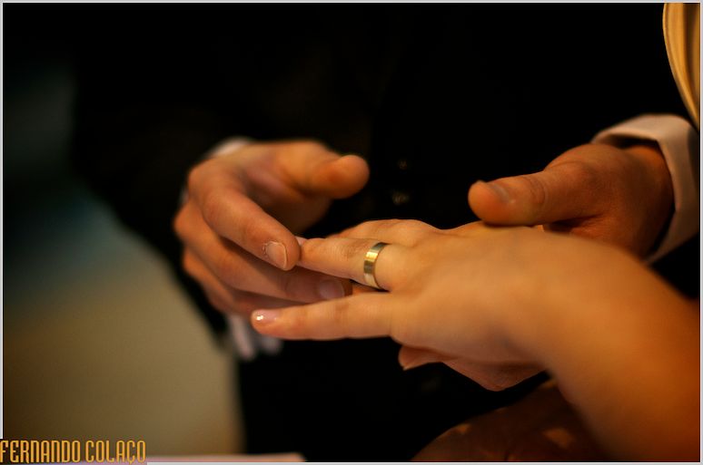 The wedding ring on the bride's finger, just put on.