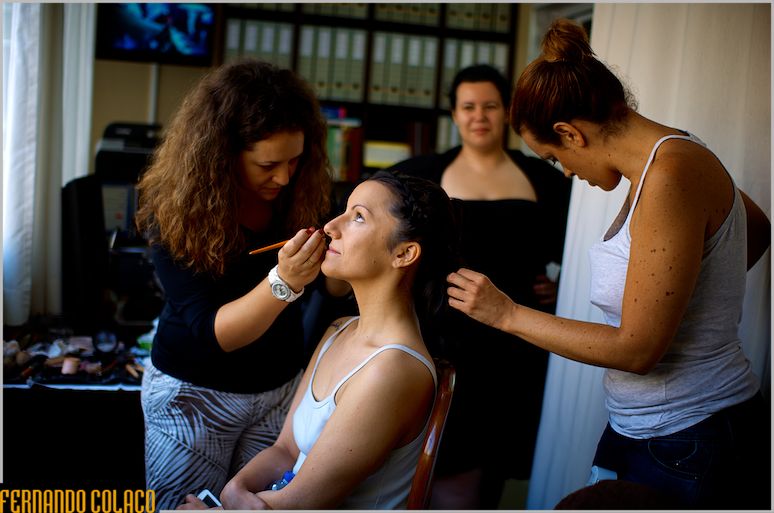 The bride under the care of the makeup artist and hairdresser.