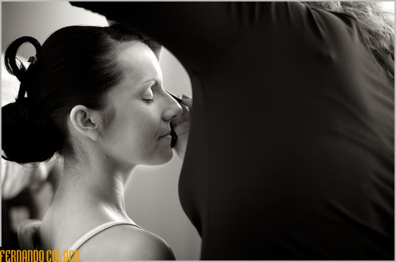 Bride in profile, at the moment her eyes are painted.
