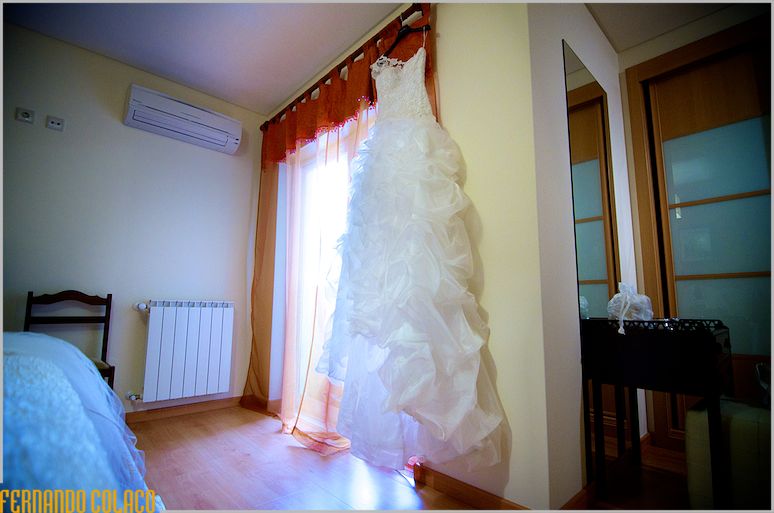 The bride's dress, hanging on the window sill.