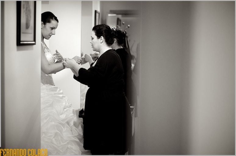 Engaged with a friend who puts the bracelet on her wrist.