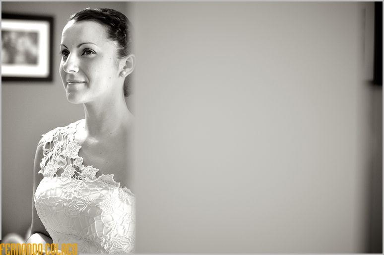 The bride, in portrait, smiles.