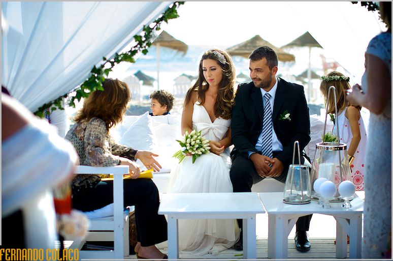 The officiating conservative talks with the couple at the wedding ceremony.
