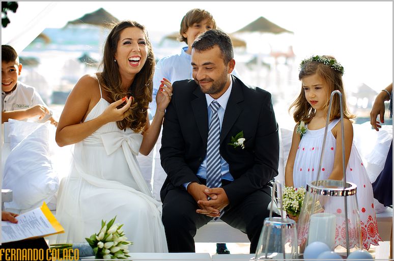 With children around, the bride chats with the groom next to her.