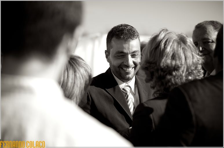 The groom among guests who congratulate him on the wedding.