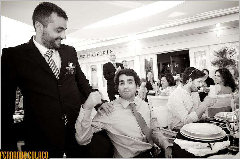 The groom with a friend invited to the wedding who greets him.