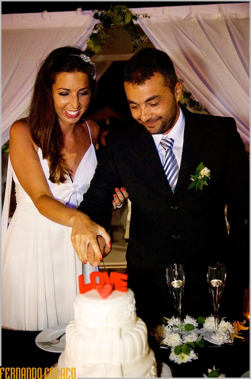 The bride and groom cut the wedding cake.