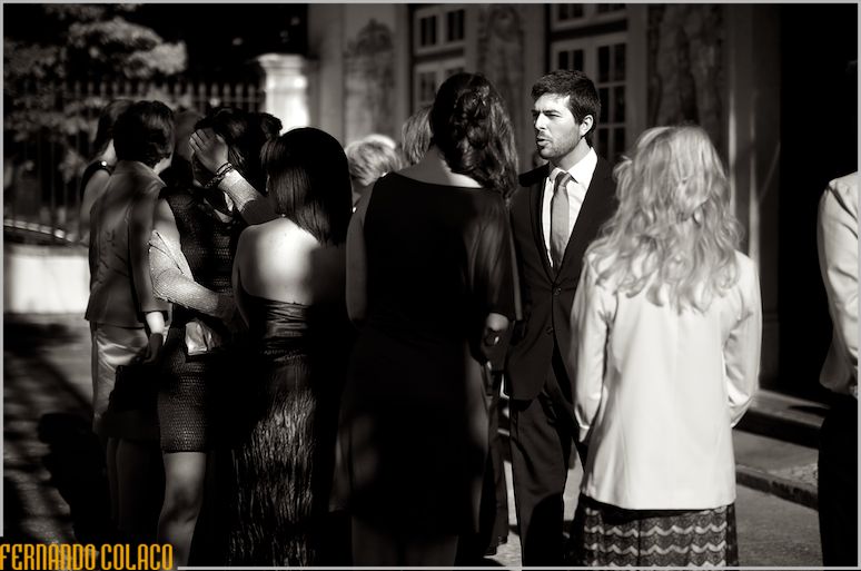 The groom in conversation with guests before the wedding ceremony.