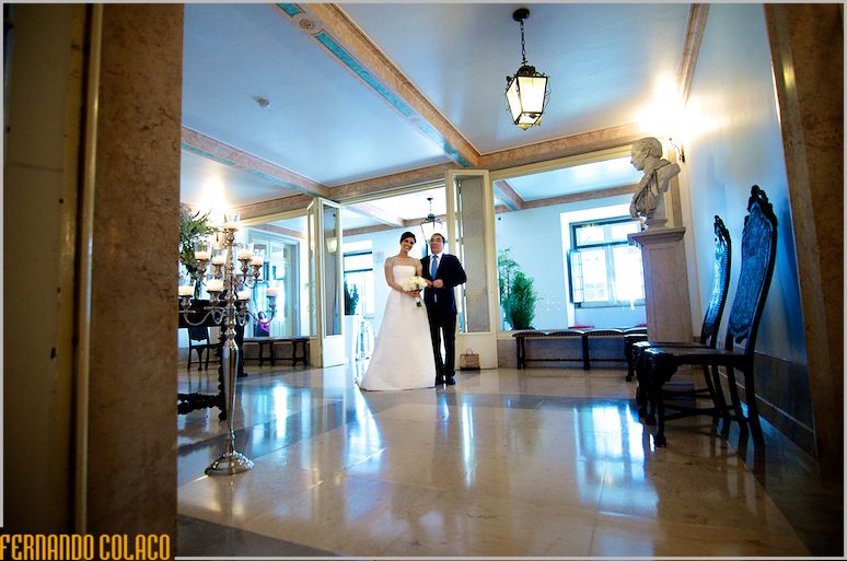 The bride with her father enters the Red Cross Palace for the wedding ceremony.