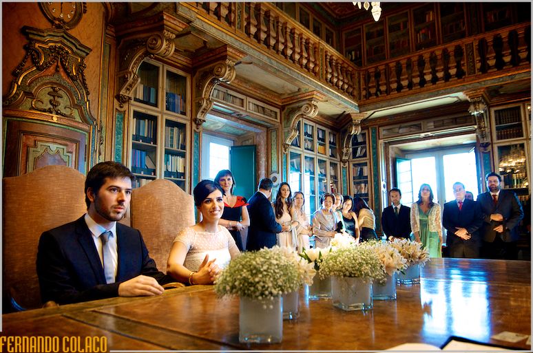 The ceremonial table, decorated with flowers, with the couple at the wedding ceremony.