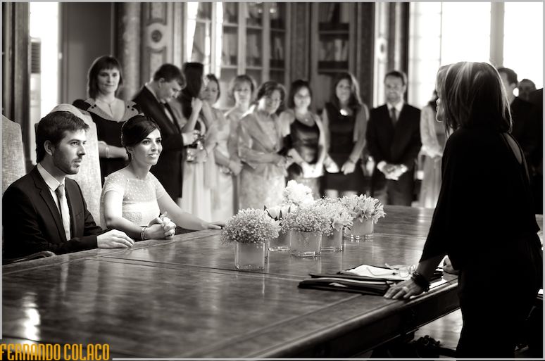 The conservative officiant of the wedding ceremony talks with the bride and groom.