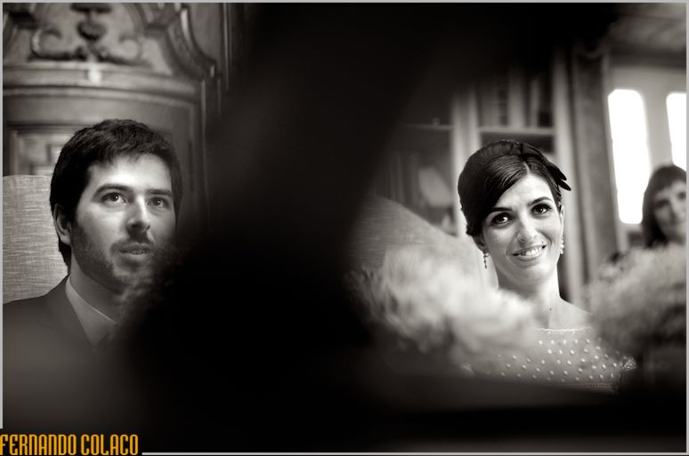 The couple looks at the officiant of their wedding ceremony.