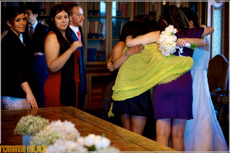 Friends of the bride hug her together as they congratulate her.