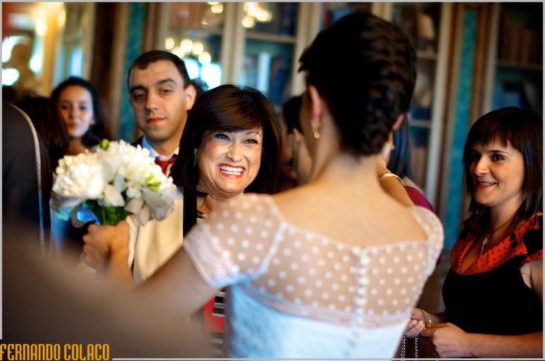 A wedding guest addresses the bride to congratulate her.