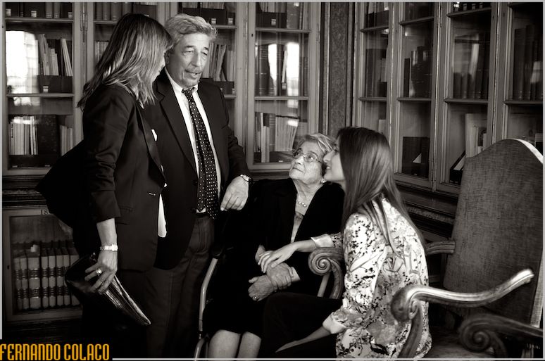 Wedding guests chat in the library of the Palácio da Cruz Vermelha, as the wedding ceremony is over.