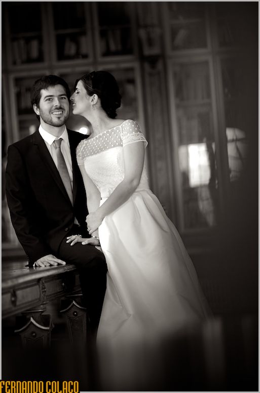 Bride whispers to the groom. sitting at a table.