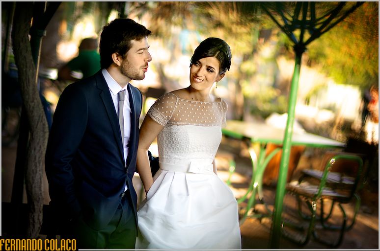 In the garden in front of the Museo de Arte Antiga, the bride and groom stroll together.