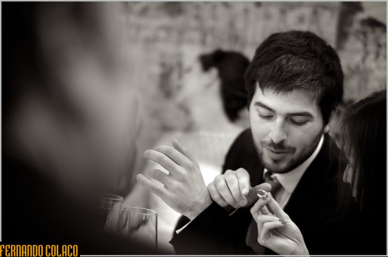 The groom shows the wedding ring to someone.