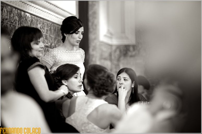 The bride, at the wedding party, in conversation with friends