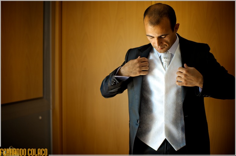 The groom has just put on his coat.