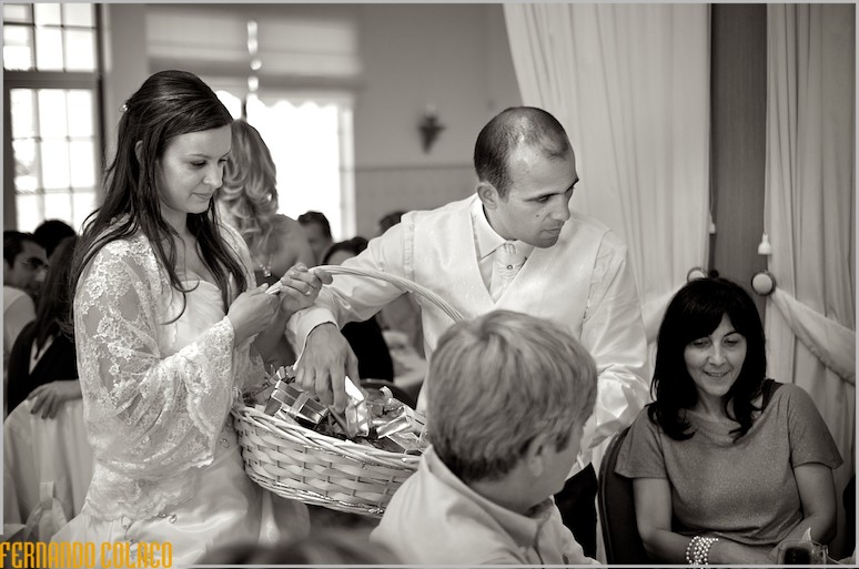 The newlywed couple distributing gifts to the guests.