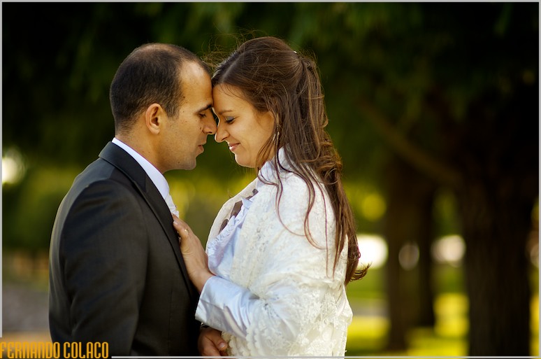 With their faces together, the couple exchanges caresses during the wedding photography session.