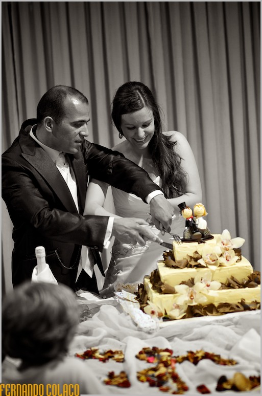 Together, the bride and groom cut the wedding cake.