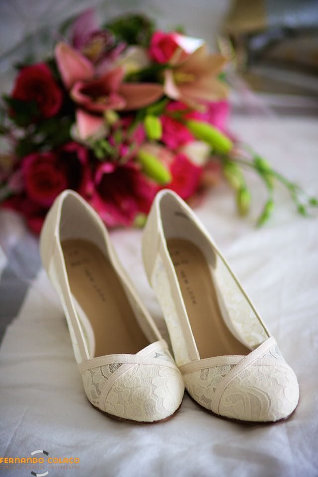 The bride's shoes in front of the bouquet.