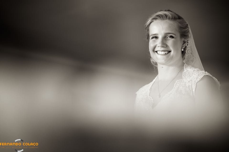 After getting ready for the wedding, the bride smiles, in a portrait by the wedding photographer.