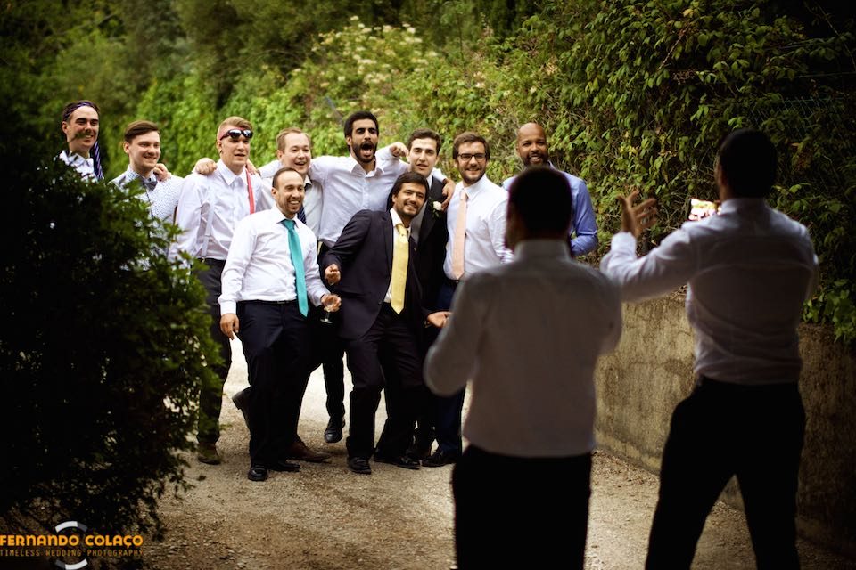 A groups of wedding guests as they take a picture.