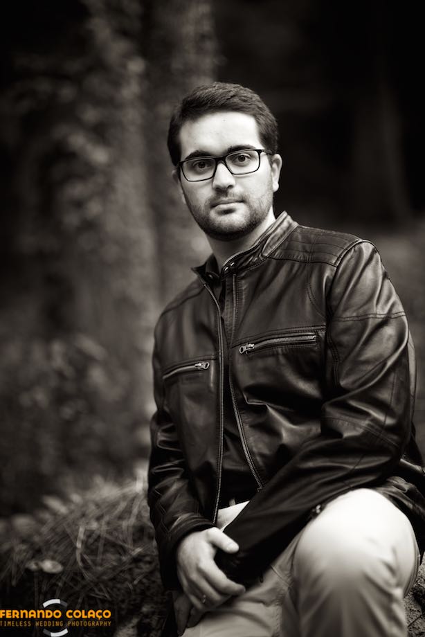 Black and white portrait of the groom looking ahead, among the trees of the Sintra mountains, in the session with the wedding photographer.
