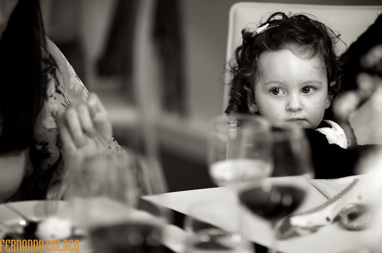 Little girl sitting at the table at a wedding.