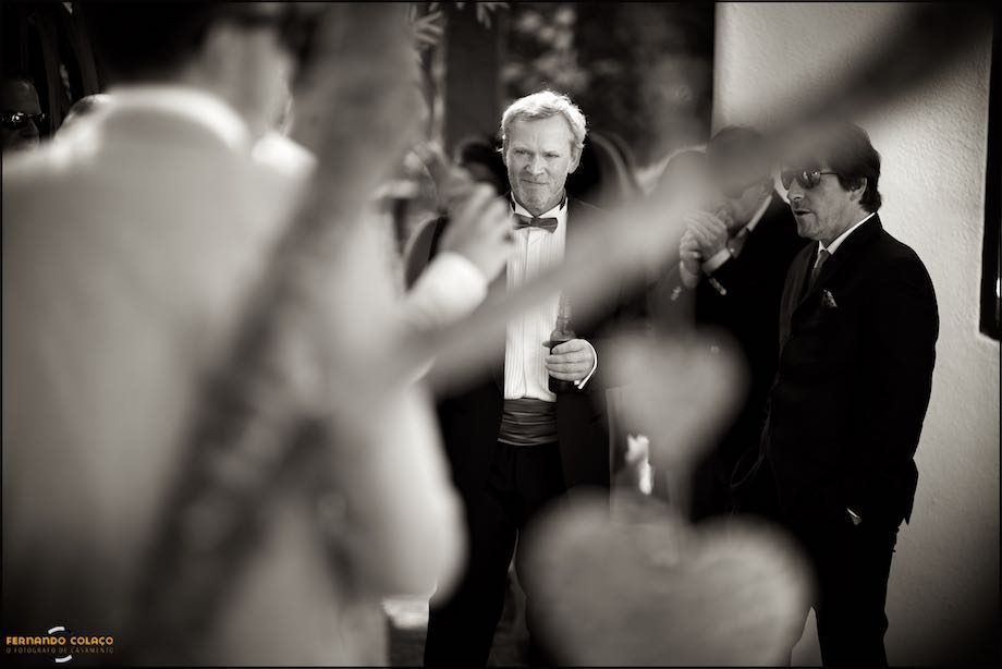 The groom in conversation with wedding guests, before the ceremony begins.