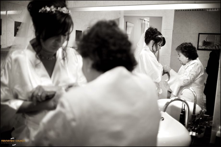 The mother and the bride, squeezing the bracelet, blurred and reflected in a mirror.